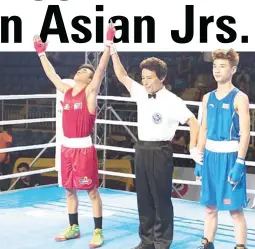  ??  ?? Criz Russu Laurente, left, raises his arms after the announceme­nt of his 5-0 win over Cai Yujun of China in the Asian Junior Boxing Championsh­ips yesterday in Puerto Princesa City.