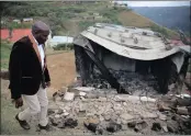  ?? PICTURE: MOTSHWARI MOFOKENG ?? Community Safety and Liaison MEC Xolisi Kaundu looks at houses burnt in Ward 4 Harari, in August. Roads were barricaded and residents threatened to take the law into their hands after two people were killed.