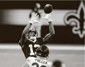  ?? Butch Dill / Associated Press ?? Saints wide receiver Michael Thomas hauls in a pass over Bears cornerback Kyle Fuller. Thomas caught his first touchdown pass since December 2019.