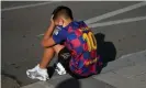  ??  ?? A young fan appears to be upset as he sits on the pavement outside Barcelona’s training ground after Lionel Messi failed to show. Photograph: Pau Barrena/AFP/Getty Images