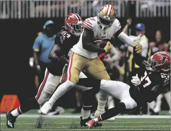  ?? AP PHOTO/JOHN BAZEMORE ?? San Francisco 49ers wide receiver Deebo Samuel (19) is tackled by Atlanta Falcons safety Richie Grant (27) and Atlanta Falcons linebacker Rashaan Evans (54) during the second half of an NFL football game, on Oct. 16 in Atlanta.