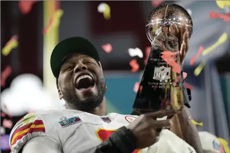  ?? ASHLEY LANDIS — THE ASSOCIATED PRESS ?? Kansas City Chiefs defensive end Carlos Dunlap celebrates with the Vince Lombardi Trophy after the NFL Super Bowl 57 football game, Sunday, Feb. 12, 2023, in Glendale, Ariz. The Kansas City Chiefs defeated the Philadelph­ia Eagles 38-35.