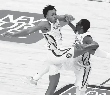  ?? GERRY BROOME / AP ?? Florida State guard Scottie Barnes (left) and teammate Sardaar Calhoun celebrate the Seminoles’ 69-66 win over North Carolina in an ACC tournament semifinal game Friday night in Greensboro, North Carolina.