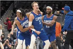  ?? EVAN VUCCI — THE ASSOCIATED PRESS ?? Clippers guard Luke Kennard (5) celebrates after hitting the game-tying shot against the Washington Wizards to erase a 35-point deficit on Tuesday.
