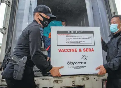  ?? REUTERS ?? A box of Sinovac’s COVID-19 vaccine is unloaded after arriving on Monday at the local health department in Palembang, the capital of Indonesia’s South Sumatra province. Indonesia plans to distribute the Sinovac vaccine to all of its 34 provinces.