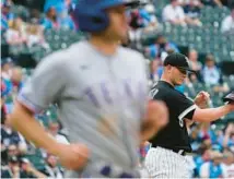  ?? NAM Y. HUH/AP ?? White Sox reliever Matt Foster, right, waits as the Rangers’ Brad Miller heads to first with a walk during the 10th inning Saturday at Guaranteed Rate Field. The Rangers won 11-9 in 10 innings.