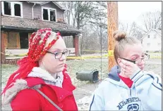  ??  ?? Melissa Thomas (right), wipes away tears as her daughter Elissa Simione looks on near the scene of a deadly fire in Youngstown, Ohio on Dec 10. Authoritie­sreport that several children died in the fire. (AP)