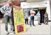  ?? Peter Hvizdak / Hearst Connecticu­t Media ?? Fans of the communitym­inded Never Ending Books gather outside the store in New Haven on Wednesday.