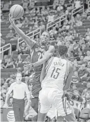  ?? Richard Carson / Associated Press ?? Grizzlies guard D.J. Stephens, top, has difficulty getting a shots off over Rockets center Clint Capela in the first half Saturday night.