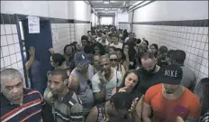  ?? Leo Correa/Associated Press ?? People wait in line to vote at a polling station in the Mare Complex slum in Rio de Janeiro, Brazil, on Sunday.