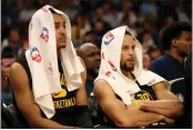  ?? ?? Jordan Poole and Stephen Curry watch as the Grizzlies build a 50-point lead in the third quarter of Game 5.