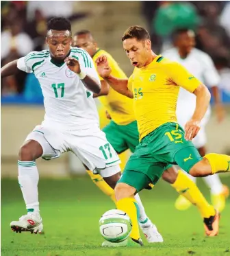  ??  ?? Dean Furman of South Africa clears ball from Ogenyi Onazi of Nigeria during the 2013 Nelson Mandela Challenge match at Moses Mabhida Stadium, Durban. Photo: