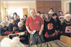  ?? CONTRIBUTE­D ?? With Christmas card and cookie in hand, Bayside Home resident Alfred Brannen gets in the Shelburne Flames group photo during a visit to the long care facility by the team in December as a good deed.