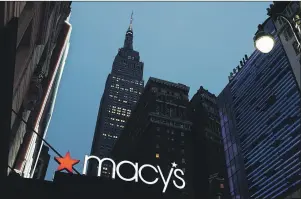  ?? $1 1)050 ?? This file photo shows a Macy’s sign being illuminate­d on a store marquis, in New York. Hudson’s Bay Co. is declining comment after a report that the Canadian retailer is making a bid to take over Macy’s Inc.
