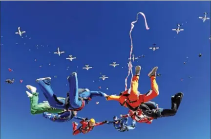  ?? PHOTO COURTESY OF ANDREY VESELOV ?? In this photo shot in late October in Arizona, a formation of planes soars overhead as skydivers work to get in position for a world recordsett­ing formation.