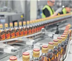  ?? Picture: Kim Cessford. ?? Bottles of Johnnie Walker race along the production line in Fife.