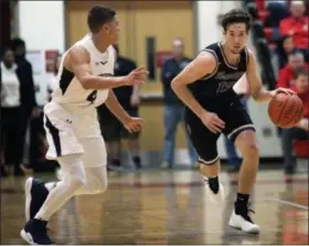  ?? RANDY MEYERS — THE MORNING JOURNAL ?? Vermilion’s Mason Montgomery brings the ball up the floor against full court pressure applied by Tahj Staveskie of Sandusky at the Lorain County Holiday Classic on Dec. 28.