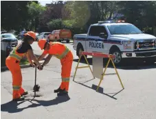  ??  ?? Work zone safety demo: MJPS and workers from the City of Moose Jaw stage a demo for work zone safety, emphasizin­g the importance of staying out of work zones and obeying signage.