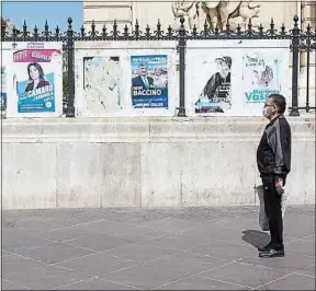  ??  ?? Un possible électeur devant les affiches des municipale­s à Marseille.