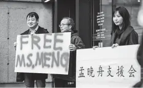  ?? James MacDonald / Bloomberg ?? People support Meng Wanzhou, chief financial officer of Huawei Technologi­es, outside a bail hearing in Vancouver, British Columbia. She was granted bail.