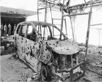  ??  ?? A damaged vehicle is seen following a raid by Saudi security forces on an Islamic State cell in Riyadh, Saudi Arabia. — Reuters photo