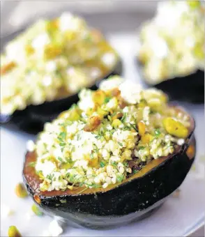  ?? CAROL BORCHARDT/SPECIAL TO THE COMMERCIAL APPEAL ?? Quinoa, Feta and Pistachio-Stuffed Acorn Squash is fine for a meatless entree or serve it as a side dish.