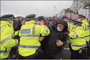  ?? STEVE PARSONS — PA ?? Truck drivers argue with police holding them back at the entrance to the Port of Dover in Kent, England, Wednesday.