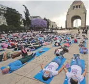  ?? AP PHOTO/FERNANDO LLANO ?? Lolling with bright blue mats, sleeping masks and travel pillows, people lie sprawled out Friday at the base of the iconic Monument to the Revolution to take a nap, in Mexico City. Dubbed the “mass siesta,” the event was in commemorat­ion of World Sleep Day.