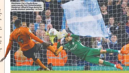  ?? REUTERSPIX ?? Manchester City’s Claudio Bravo saves a penalty from Wolverhamp­ton Wanderers’ Alfred N’Diaye during the penalty shootout yesterday –