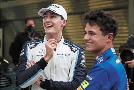  ?? — ap ?? Youngsters going places: Mclaren’s Lando norris celebrates pole position with Williams’ George russell (left) who ended up third on the grid, after the qualifying session of the russian Grand prix on Saturday.