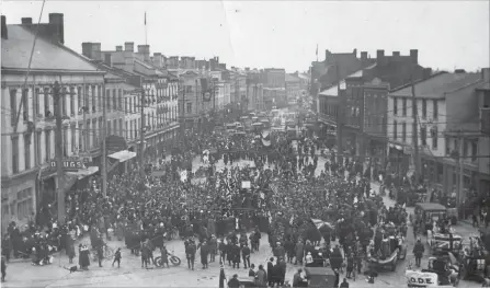  ?? H.C. GOODMAN RON GOODMAN ?? As bells ring out, people begin to flood into downtown St. Catharines, led by night-shift workers at the Steel &amp; Metal Co. plant on Geneva Street, soon followed by workers from McKinnon Industries.