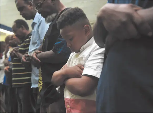  ?? CITIZEN NEWS SERVICE FILE PHOTO ?? Tyler Jabari-Rainey, 9, prays at Masjid Muhammad, a Washington mosque, during Ramadan in 2016.