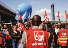  ?? Thomas Padilla / Associated Press ?? Airport workers seeking higher pay to keep up with inflation rally outside a terminal at Paris’ Charles de Gaulle Airport.