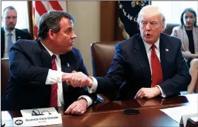  ?? AP/EVAN VUCCI ?? President Donald Trump shakes hands with New Jersey Gov. Chris Christie during an opioid and drug abuse listening session Wednesday in the Cabinet Room of the White House in Washington.