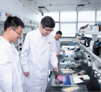  ??  ?? Lei Zhen (center) in the lab of his tech company in Zhuhai, Guangdong Province in south China. Lei, a resident of Macao, set up the company in 2015