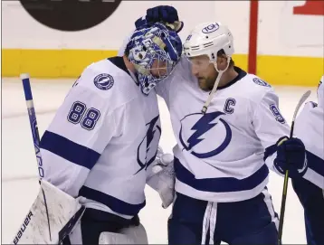  ?? REINHOLD MATAY — THE ASSOCIATED PRESS ?? The Lightning's Steven Stamkos, right, and Andrei Vasilevski­y celebrate after defeating the Panthers in Game 1on Tuesday.