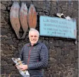  ??  ?? Neil Robson with one of his kippers from the family smokery.