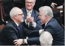  ?? MAT H I E U B E L A NG E R / T H E C A NA D I A N P R E S S ?? Finance Minister Carlos Leitão is congratula­ted by Premier Philippe Couillard after presenting a provincial budget on Thursday at the legislatur­e in Quebec City.