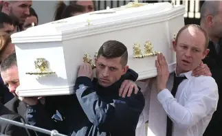  ?? Photo: Damien Eagers ?? Heartbroke­n Martin Carey (rear right), father of Kayla Carey (pictured left), carries her coffin at the funeral at St Mary’s Church, Navan, Co Meath.