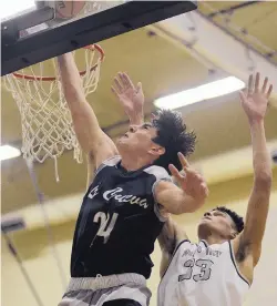  ?? ADOLPHE PIERRE-LOUIS/JOURNAL ?? La Cueva’s Isaiah Ortega, left, puts up a shot in front of Volcano Vista’s Terrin Dickey during their game Monday night.