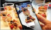  ?? ASSOCIATED PRESS ?? IN THIS FEB. 21 file photo the Bixby virtual assistant software of a Samsung Galaxy S9 Plus mobile phone identifies food and displays its calories during a product preview in New York.
FREEZING MOTION