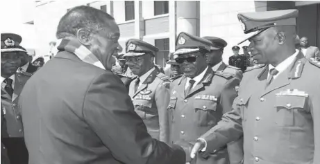  ??  ?? President-elect Cde Emmerson Mnangagwa greets Zimbabwe Defence Forces Commander General Phillip Valerio Sibanda, while Major-General Hlanganani Dube and Air Force of Zimbabwe Commander Air Marshal Elson Moyo look on after a graduation ceremony at the Zimbabwe National Defence University yesterday. — (Picture by John Manzongo)