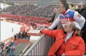  ?? ASSOCIATED PRESS ?? IN THIS FILE PHOTO TAKEN MARCH 8, 2014, Russian President Vladimir Putin, foreground, watches the downhill ski competitio­n of the 2014 Winter Paralympic­s in Roza Khutor mountain district of Sochi, Russia, as Russia’s sports minister Vitaly Mutko stands...