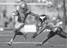  ?? ASHLEY LANDIS/AP ?? UCLA running back Keegan Jones carries against Utah safety R.J. Hubert on Saturday in Pasadena, Calif.