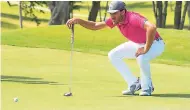  ??  ?? Jamaica’s Jonathan Newnham lines up a shot before putting in the BMW Jamaica Classic Qualifiers at the Cinnamon Hill Golf Club yesterday.