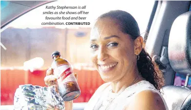  ?? CONTRIBUTE­D ?? Kathy Stephenson is all smiles as she shows off her favourite food and beer combinatio­n.