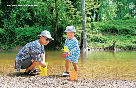  ??  ?? Helen Cho, of Columbia, and her 2-year-old son Timothy play in a stretch of the Patapsco River at Patapsco Valley State Park. Like many Marylander­s, they’ve been searching for outdoor spaces since the coronaviru­s pandemic began.