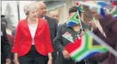  ?? REUTERS ?? British Prime Minister Theresa May is greeted by school children waving flags during her visit in South Africa on Tuesday.