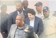  ?? AFP ?? FTX founder Sam Bankman-Fried, centre, is led away by officers of the Royal Bahamas Police Force.