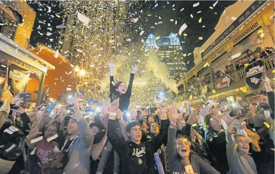  ?? PHOTOS BY RICARDO RAMIREZ BUXEDA/STAFF PHOTOGRAPH­ER ?? UCF fans show their support one more time for their hometown team as they cheer on the Knights during Monday’s National Championsh­ip Block Party in downtown Orlando.